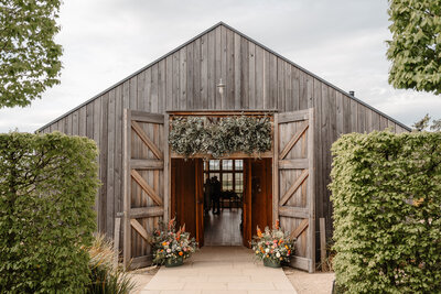 Wedding ceremony flower arrangements at Hyde House - elegant bridal arch and aisle decorations